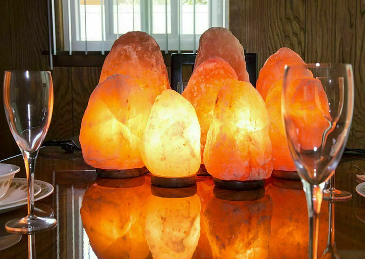 Authentic Pink Himalayan Salt Lamp glowing on a wooden table